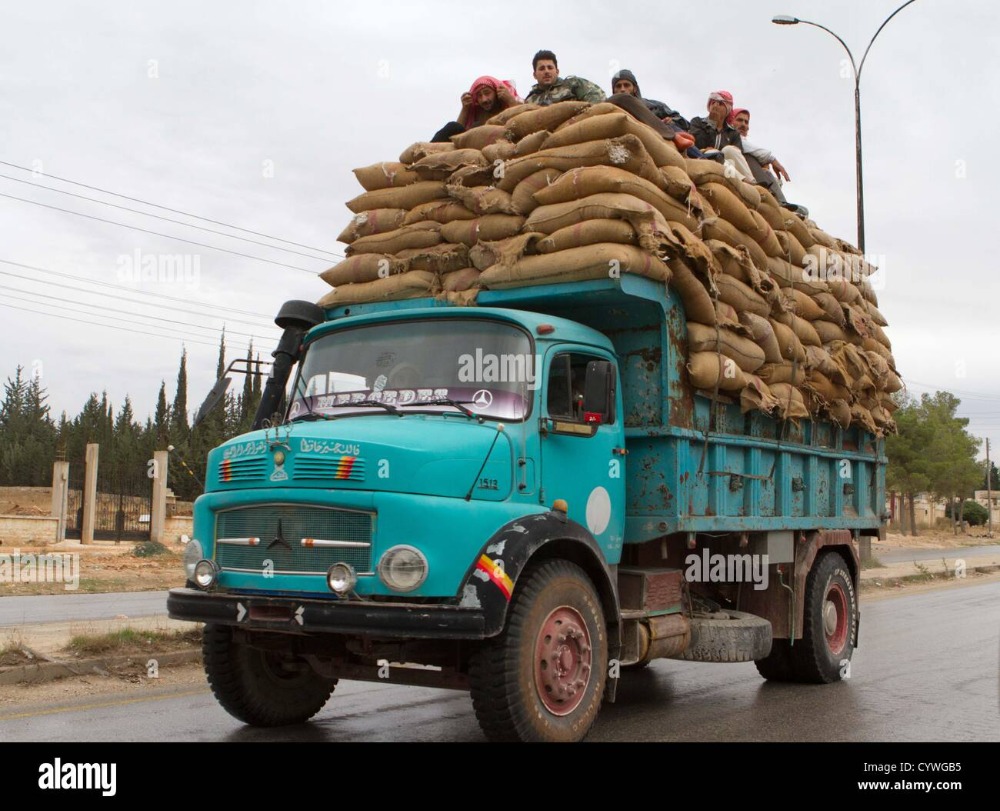 november-9-2012-layramoon-syria-men-sit-on-top-of-an-overloaded-truck-CYWGB5.jpg